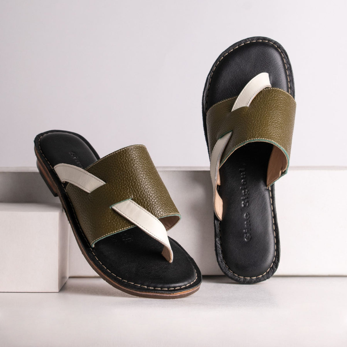Leather slides with crossover straps, side view