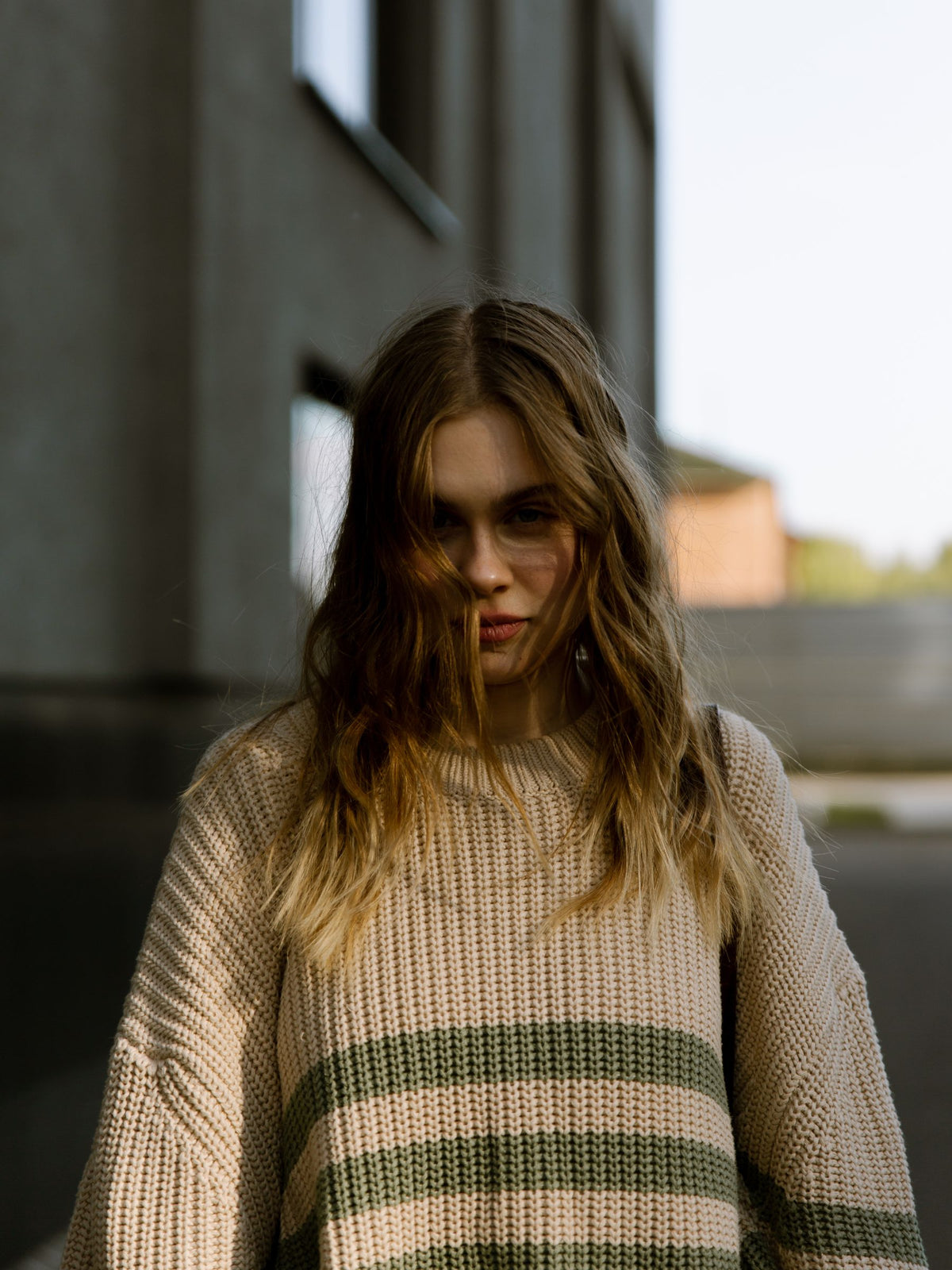 Model in a cream striped oversized knit sweater