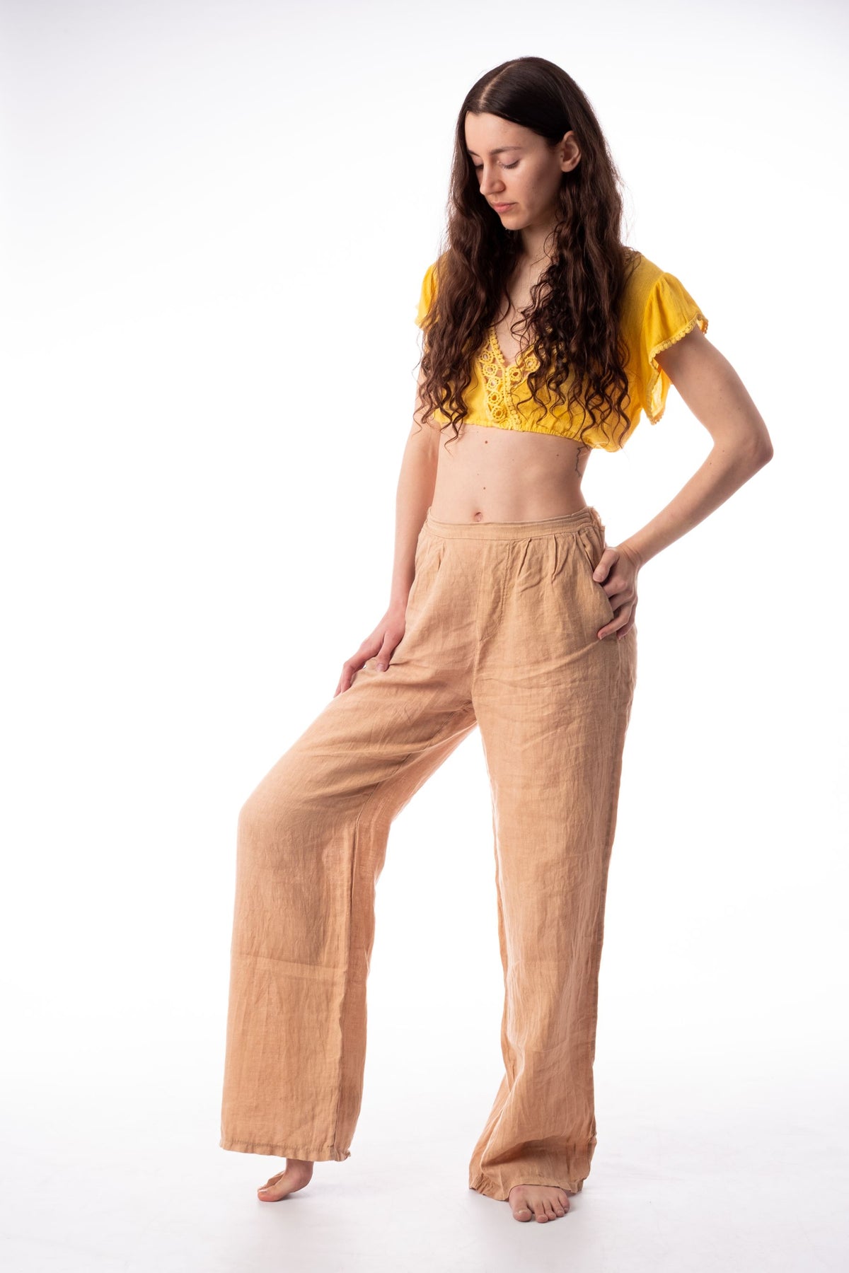Model in apricot wide-leg linen trousers