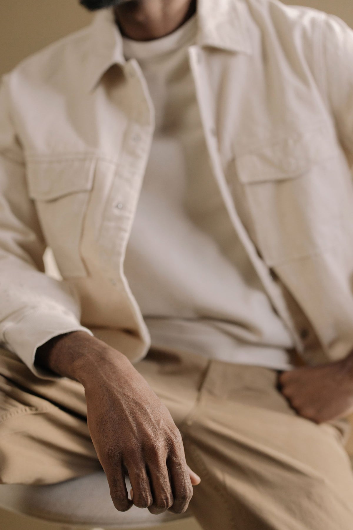 Chest pocket detail of the cream utility overshirt