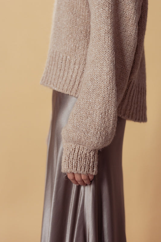 Champagne satin slip skirt worn with a chunky knit sweater