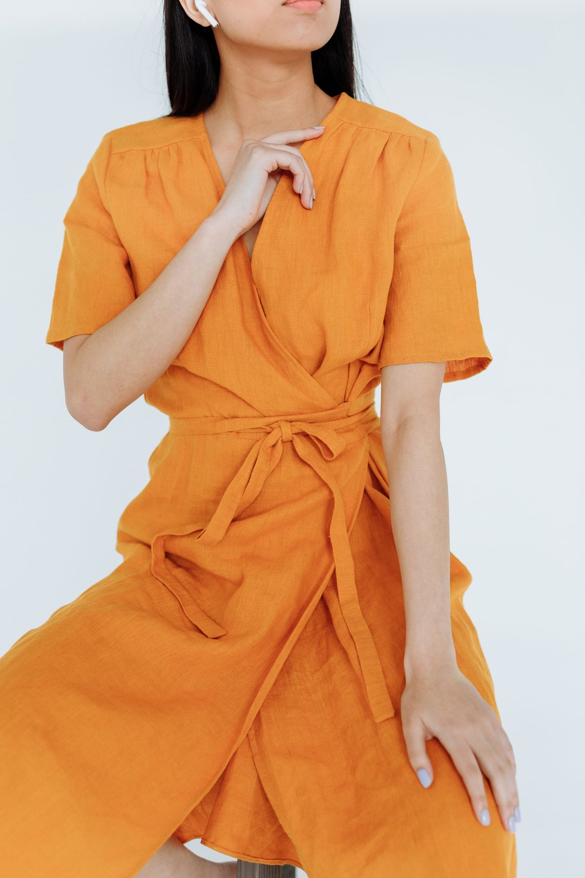 Model in a saffron linen wrap dress
