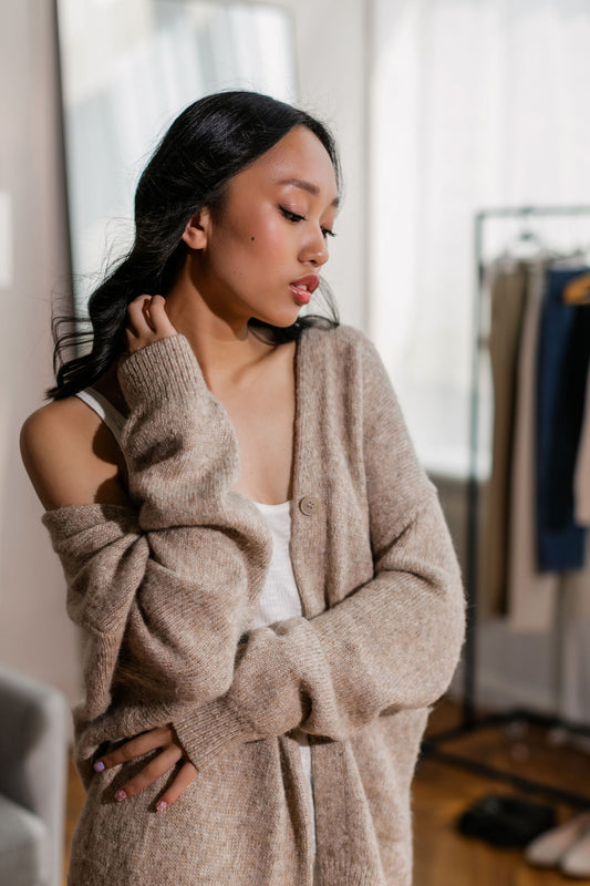 Model in an oatmeal chunky knit cardigan