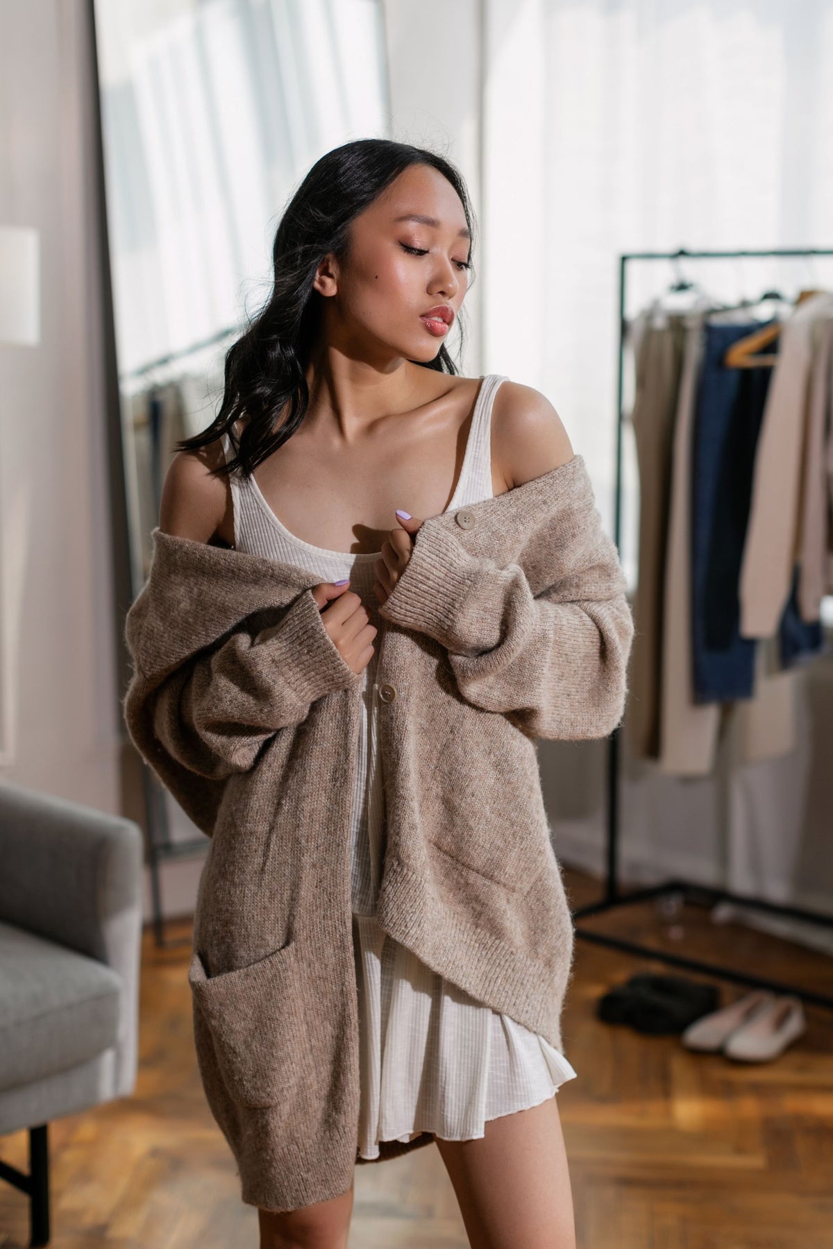 Oatmeal chunky knit cardigan worn over a slip dress
